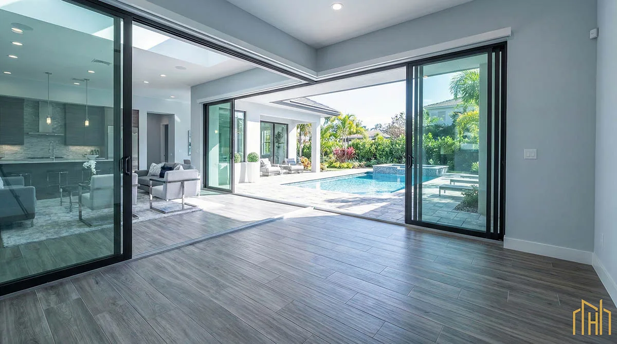 Durable wood-look porcelain tile flooring in an entryway leading to a backyard pool, perfect for Texas heat.