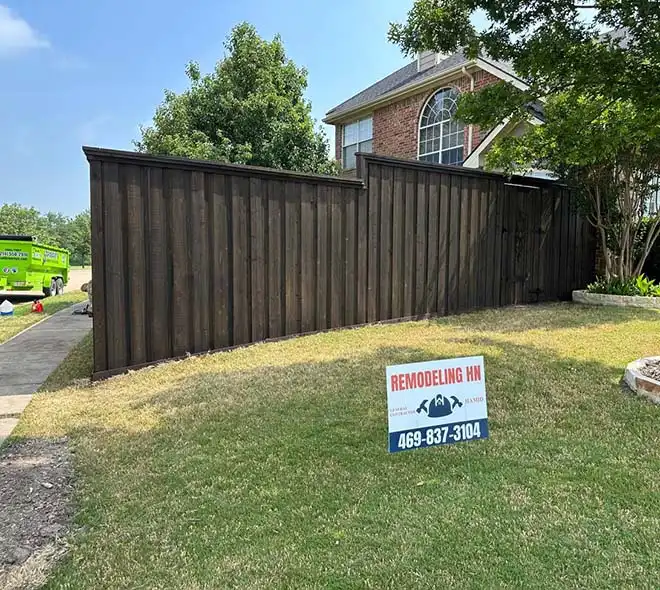 Newly installed perimeter fence around residential property after exterior renovation