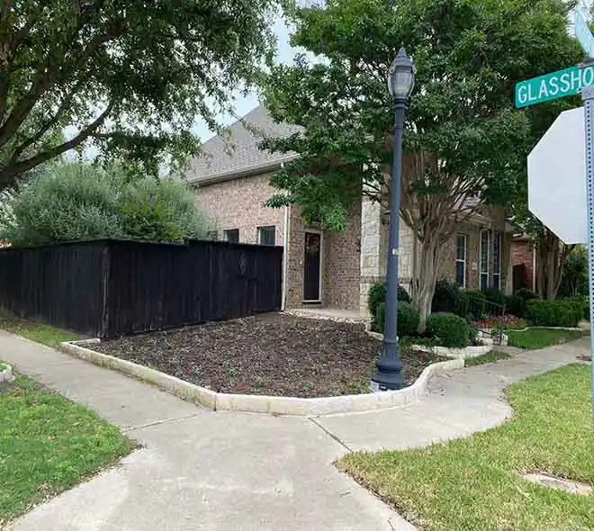 Backyard landscaping project with wooden garden wall and stone paving