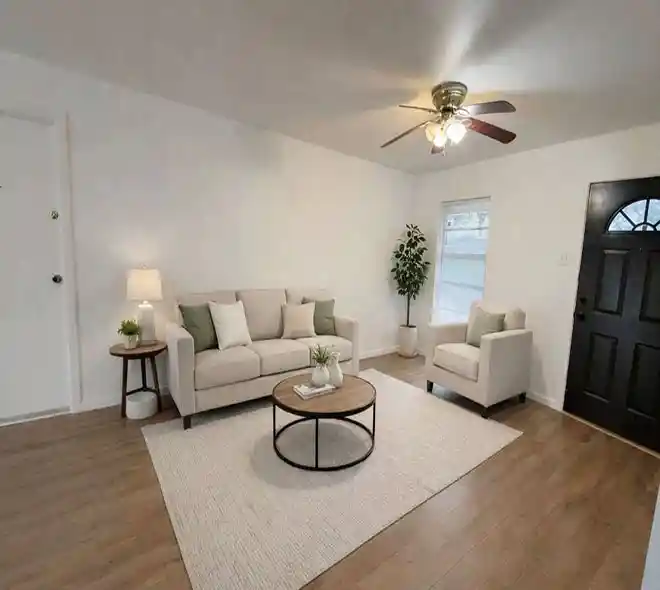Modern living room after renovation featuring updated flooring and contemporary design