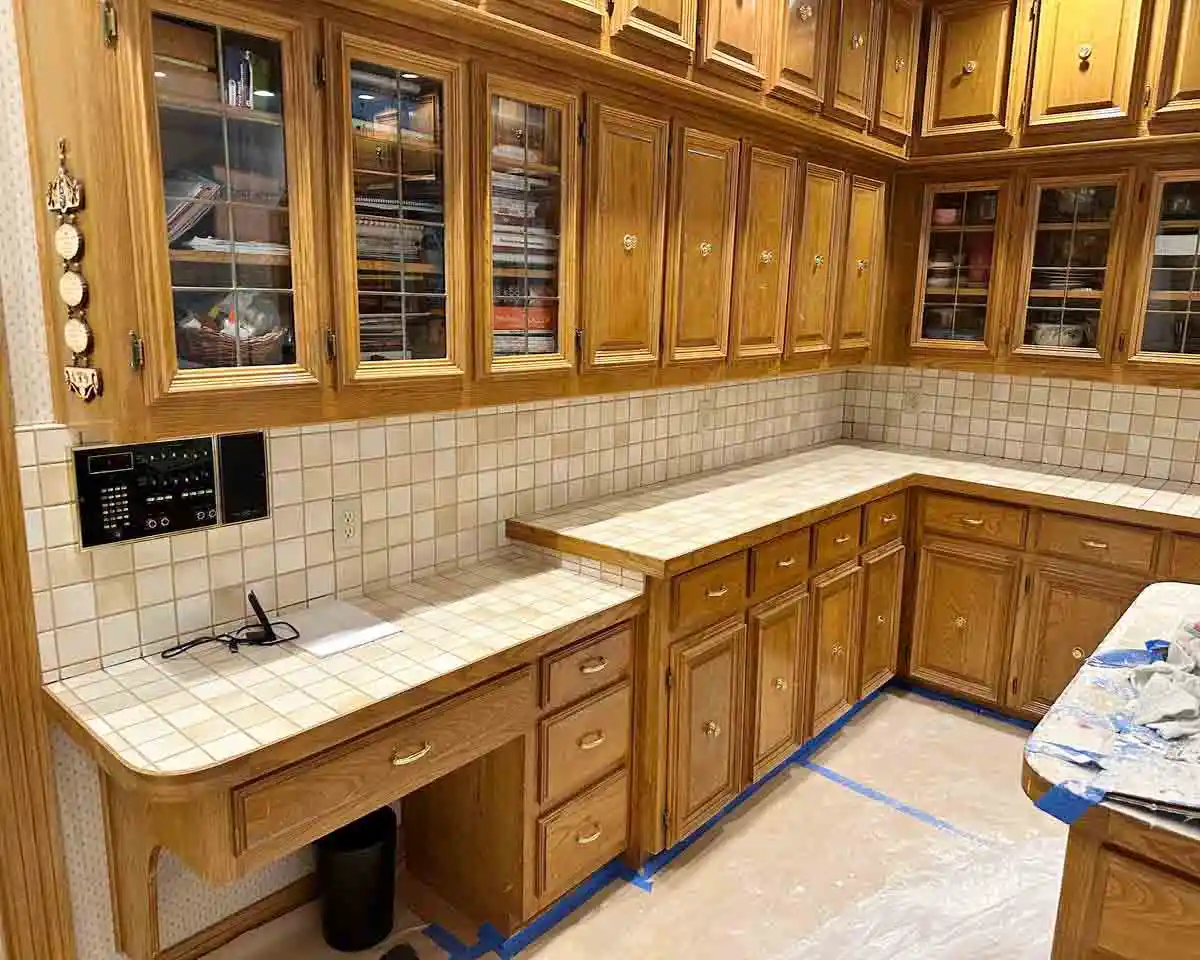 Outdated kitchen in Plano, TX before remodeling with old cabinets, old island, and outdated stove wall